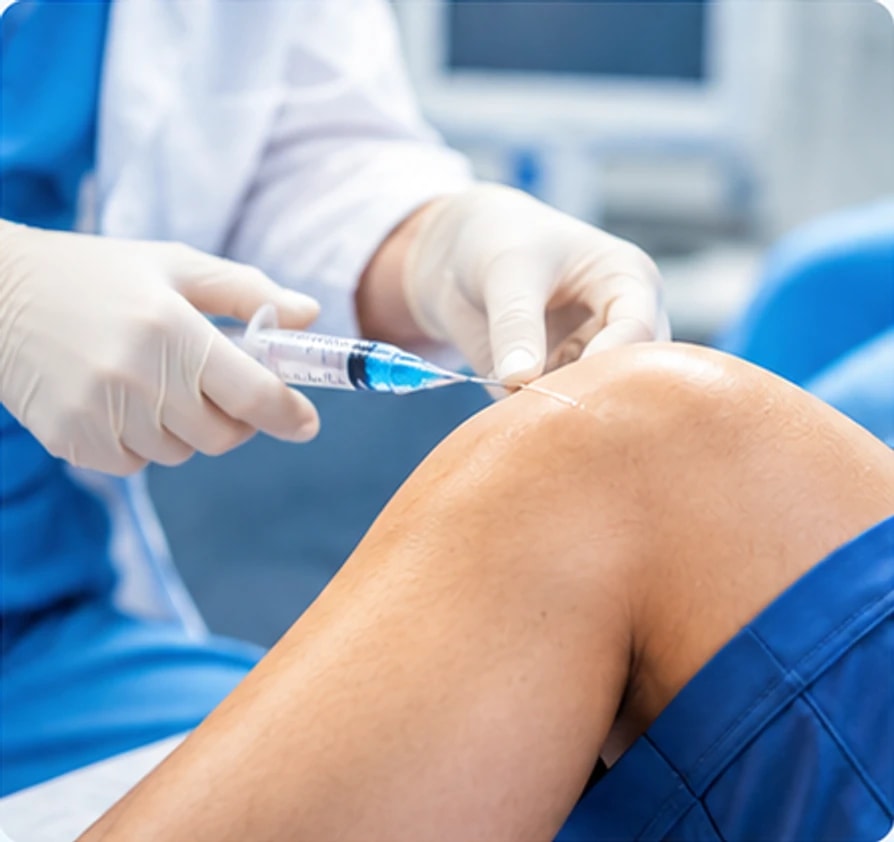 A clinician guiding a needle into a patient's knee joint
