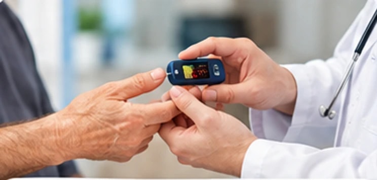 A clinician checking a patient's finger with a pulse oximeter